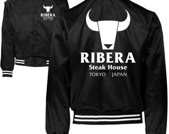 May include: A black satin varsity jacket featuring white striped ribbed trim on the collar, cuffs, and hem. The front and back display a white bull head logo above the text RIBERA Steak House TOKYO JAPAN in a bold, clean, sans-serif font.