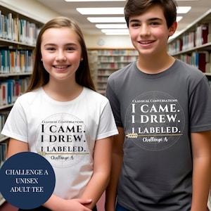 May include: Two people wearing white and grey t-shirts with the text "I CAME. I DREW. I LABELED." The shirts also feature the words "Classical Conversations" and "Challenge A." The shirts are unisex adult tees.