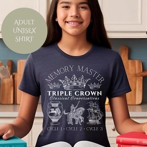 May include: Navy blue adult unisex t-shirt featuring the text "MEMORY MASTER TRIPLE CROWN Classical Conversations" in white, along with illustrations of a vase, a knight, and a ship. The shirt also has the text "CYCLE 1 CYCLE 2 CYCLE 3".