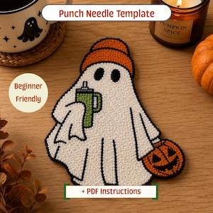 May include: A punch needle template featuring a white ghost wearing an orange beanie, holding a green tumbler and a small orange jack-o'-lantern. The design includes black outlines and the text Punch Needle Template and + PDF Instructions.