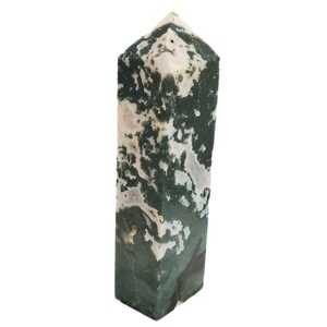 May include: A tall, rectangular moss agate crystal point. The polished stone features a mix of dark green and white patterns. The top is a pointed, angled shape. The crystal is standing upright against a white background.