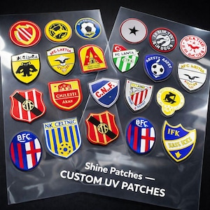 May include: A collection of colorful, custom UV patches featuring various team logos and emblems. The patches are in various shapes, including circles and shields, with text that reads "Shine Patches - CUSTOM UV PATCHES".