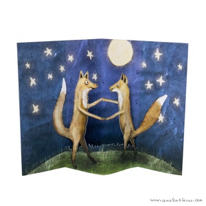 May include: Two foxes dance under a full moon and a starry night sky. The foxes are brown and orange with white accents. The background is a dark blue with white stars and a yellow moon.