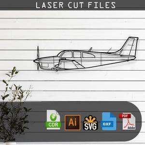 May include: Black metal airplane wall art, mounted on a white wooden plank background. The airplane is a detailed outline. The text "LASER CUT FILES" is at the top. Below the airplane are file type icons: CDR, AI, SVG, DXF, and PDF.