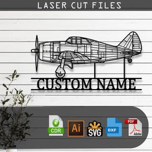 May include: A black laser-cut metal wall art piece featuring a detailed side profile of a propeller airplane. Below the aircraft, a horizontal bar displays the text CUSTOM NAME in bold capital letters. File format icons are visible below.