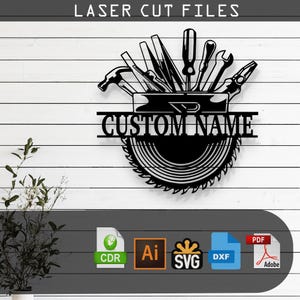 May include: Black metal laser cut file design featuring tools, a saw blade, and the text "CUSTOM NAME". The design includes a hammer, screwdrivers, a wrench, and pliers. The words "LASER CUT FILES" are at the top.