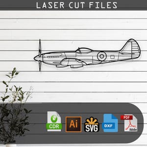May include: A black and white line drawing of a vintage airplane, a Spitfire, with the text "LASER CUT FILES" at the top of the image. Below the airplane are icons for the file types available for download: CDR, AI, SVG, DXF, and PDF.