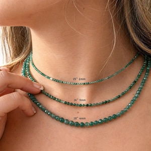 May include: Three layered necklaces made of small, faceted green gemstone beads. The top necklace is 15 inches long with 2mm beads, the middle is 16 inches long with 3mm beads, and the bottom necklace is 18 inches long with 4mm beads.