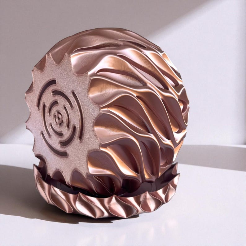 A 3D‑printed planter with a curvy cylindrical form, featuring bold vertical chunky wavy ridges that twist elegantly from top to bottom. The pot includes drainage holes and comes with a matching drip tray that mirrors the same sculptural surface design. Made from glossy Rose Gold Silk PLA, the planter has a luminous sheen that enhances its contemporary art aesthetic.