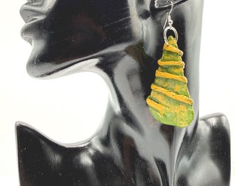 May include: A triangular-shaped dangle earring featuring a textured green surface with raised, horizontal yellow stripes. The earring is attached to a silver-toned metal hook, creating a distinct contrast between the vibrant colors and the metallic hardware.