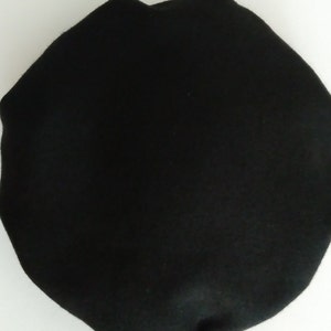 May include: A black beret made of wool.