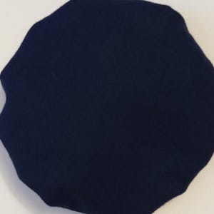 May include: A solid dark blue fabric shower cap.