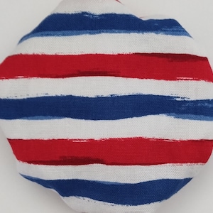 May include: Red, white, and blue striped fabric with a brushstroke pattern. The fabric is folded into a circle.