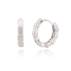 May include: A pair of silver-colored hoop earrings. One earring is open, and the other is closed. The earrings have a segmented design, with each segment appearing rectangular. The earrings are displayed on a white surface.