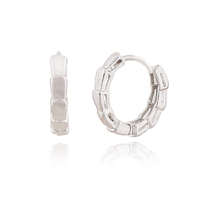 May include: A pair of silver-colored hoop earrings. One earring is open, and the other is closed. The earrings have a segmented design, with each segment appearing rectangular. The earrings are displayed on a white surface.