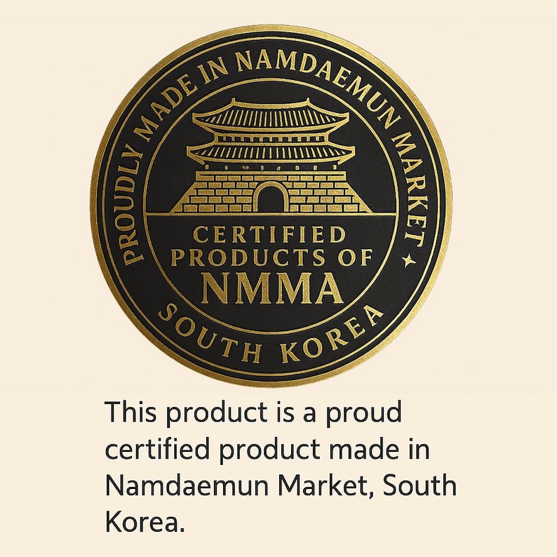 May include: A circular black and gold seal with the text "Proudly Made in Namdaemun Market, South Korea." The seal features a traditional Korean building and the text "Certified Products of NMMA."