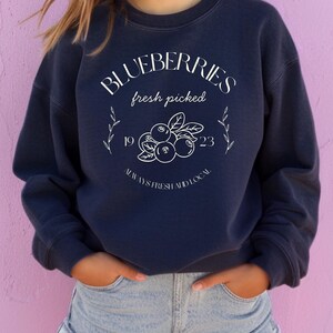 Printed on a soft-washed Comfort Colors 1566 crewneck, this sweatshirt has that lived-in feel right from the first wear. With its relaxed fit and pigment-dyed fabric, it pairs perfectly with your favorite denim, leggings, or cutoff shorts for a cozy-cute summer loo