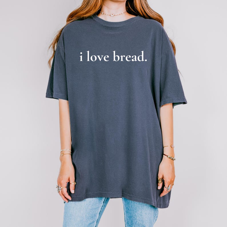 Simple. Honest. Relatable.
This “I Love Bread” Comfort Colors t-shirt is made for anyone who believes bread deserves more appreciation. Featuring clean, minimalist text and a soft, lived-in feel, this tee is the perfect blend of humor and everyday comfort.