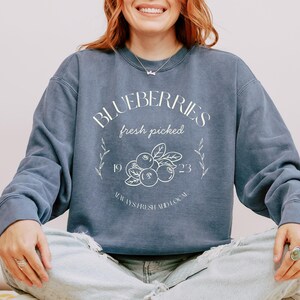 Printed on a soft-washed Comfort Colors 1566 crewneck, this sweatshirt has that lived-in feel right from the first wear. With its relaxed fit and pigment-dyed fabric, it pairs perfectly with your favorite denim, leggings, or cutoff shorts for a cozy-cute summer loo