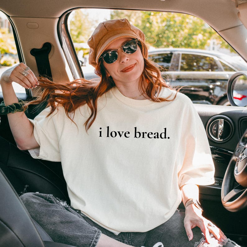Simple. Honest. Relatable.
This “I Love Bread” Comfort Colors t-shirt is made for anyone who believes bread deserves more appreciation. Featuring clean, minimalist text and a soft, lived-in feel, this tee is the perfect blend of humor and everyday comfort.