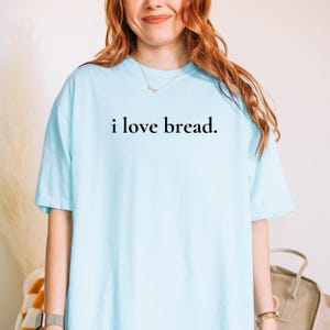 Simple. Honest. Relatable.
This “I Love Bread” Comfort Colors t-shirt is made for anyone who believes bread deserves more appreciation. Featuring clean, minimalist text and a soft, lived-in feel, this tee is the perfect blend of humor and everyday comfort.