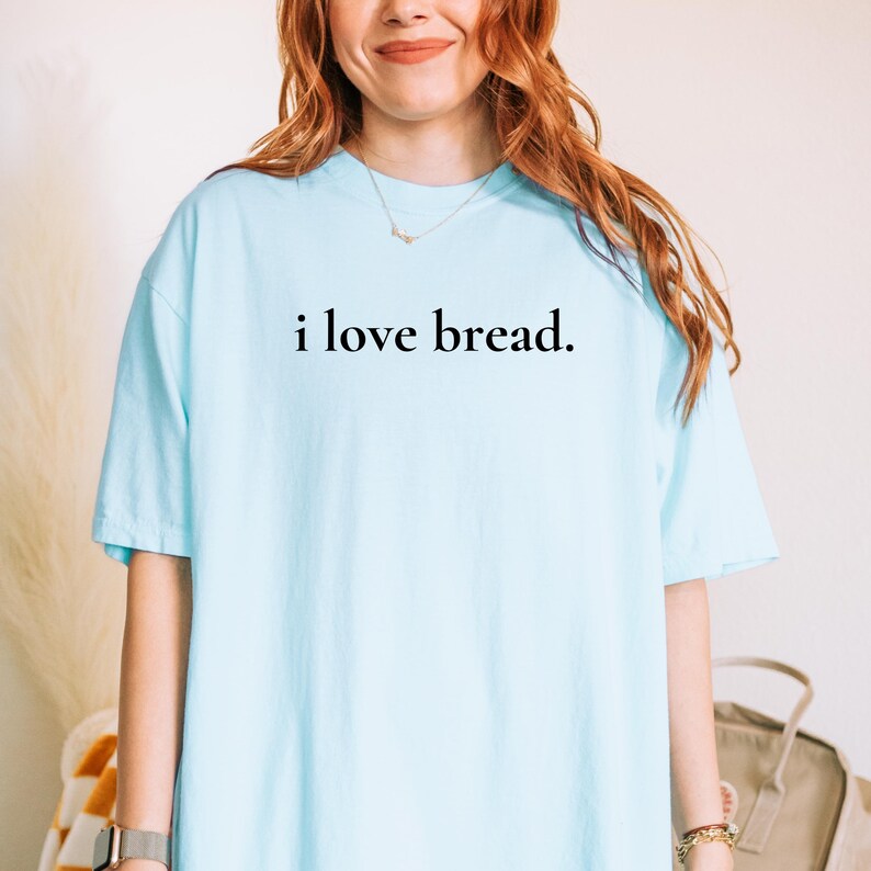 Simple. Honest. Relatable.
This “I Love Bread” Comfort Colors t-shirt is made for anyone who believes bread deserves more appreciation. Featuring clean, minimalist text and a soft, lived-in feel, this tee is the perfect blend of humor and everyday comfort.