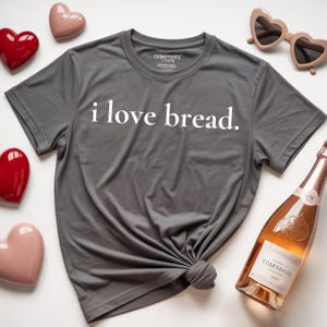 Simple. Honest. Relatable.
This “I Love Bread” Comfort Colors t-shirt is made for anyone who believes bread deserves more appreciation. Featuring clean, minimalist text and a soft, lived-in feel, this tee is the perfect blend of humor and everyday comfort.