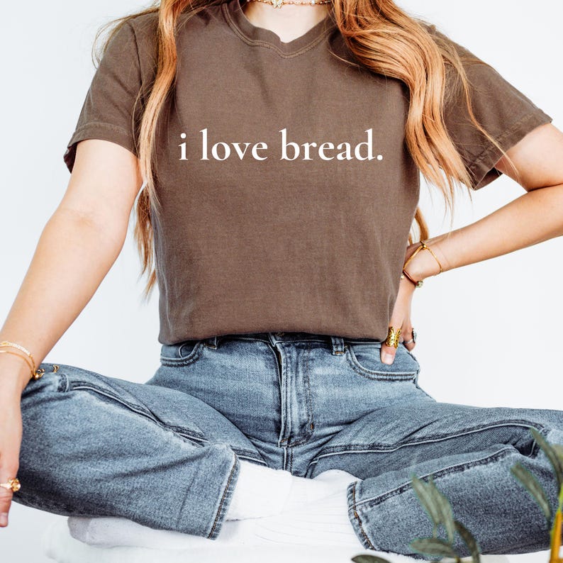 Simple. Honest. Relatable.
This “I Love Bread” Comfort Colors t-shirt is made for anyone who believes bread deserves more appreciation. Featuring clean, minimalist text and a soft, lived-in feel, this tee is the perfect blend of humor and everyday comfort.