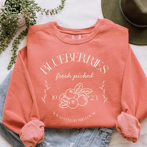 Printed on a soft-washed Comfort Colors 1566 crewneck, this sweatshirt has that lived-in feel right from the first wear. With its relaxed fit and pigment-dyed fabric, it pairs perfectly with your favorite denim, leggings, or cutoff shorts for a cozy-cute summer loo