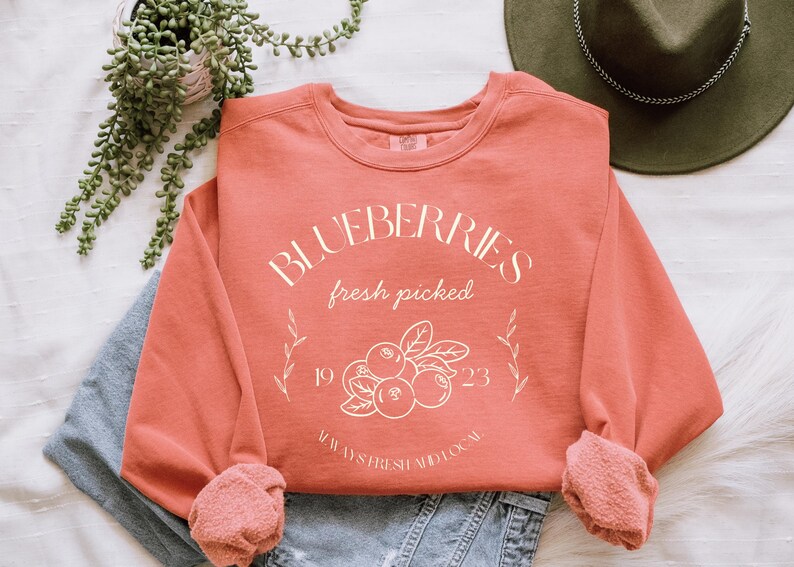 Printed on a soft-washed Comfort Colors 1566 crewneck, this sweatshirt has that lived-in feel right from the first wear. With its relaxed fit and pigment-dyed fabric, it pairs perfectly with your favorite denim, leggings, or cutoff shorts for a cozy-cute summer loo
