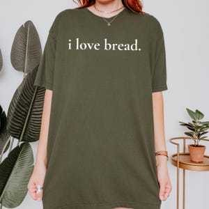 Simple. Honest. Relatable.
This “I Love Bread” Comfort Colors t-shirt is made for anyone who believes bread deserves more appreciation. Featuring clean, minimalist text and a soft, lived-in feel, this tee is the perfect blend of humor and everyday comfort.