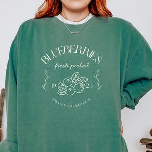 Printed on a soft-washed Comfort Colors 1566 crewneck, this sweatshirt has that lived-in feel right from the first wear. With its relaxed fit and pigment-dyed fabric, it pairs perfectly with your favorite denim, leggings, or cutoff shorts for a cozy-cute summer loo