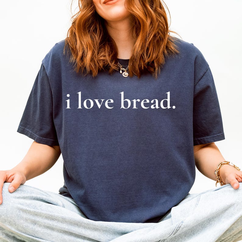 Simple. Honest. Relatable.
This “I Love Bread” Comfort Colors t-shirt is made for anyone who believes bread deserves more appreciation. Featuring clean, minimalist text and a soft, lived-in feel, this tee is the perfect blend of humor and everyday comfort.