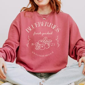 Printed on a soft-washed Comfort Colors 1566 crewneck, this sweatshirt has that lived-in feel right from the first wear. With its relaxed fit and pigment-dyed fabric, it pairs perfectly with your favorite denim, leggings, or cutoff shorts for a cozy-cute summer loo