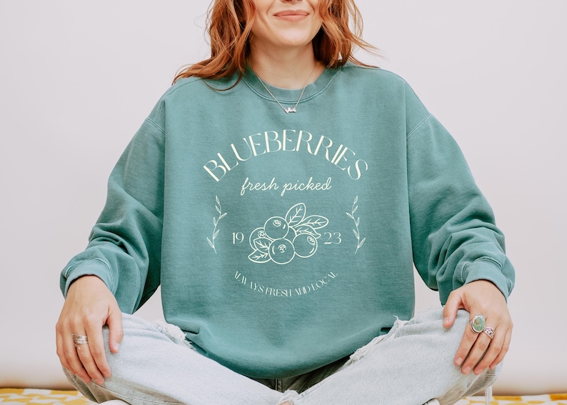 Printed on a soft-washed Comfort Colors 1566 crewneck, this sweatshirt has that lived-in feel right from the first wear. With its relaxed fit and pigment-dyed fabric, it pairs perfectly with your favorite denim, leggings, or cutoff shorts for a cozy-cute summer loo