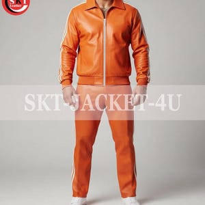 May include: Orange leather jacket and pants set with white stripes. The jacket has a zip-up front and a collar. The pants have a straight leg design. The text "SKT JACKET-4U" is displayed across the image.