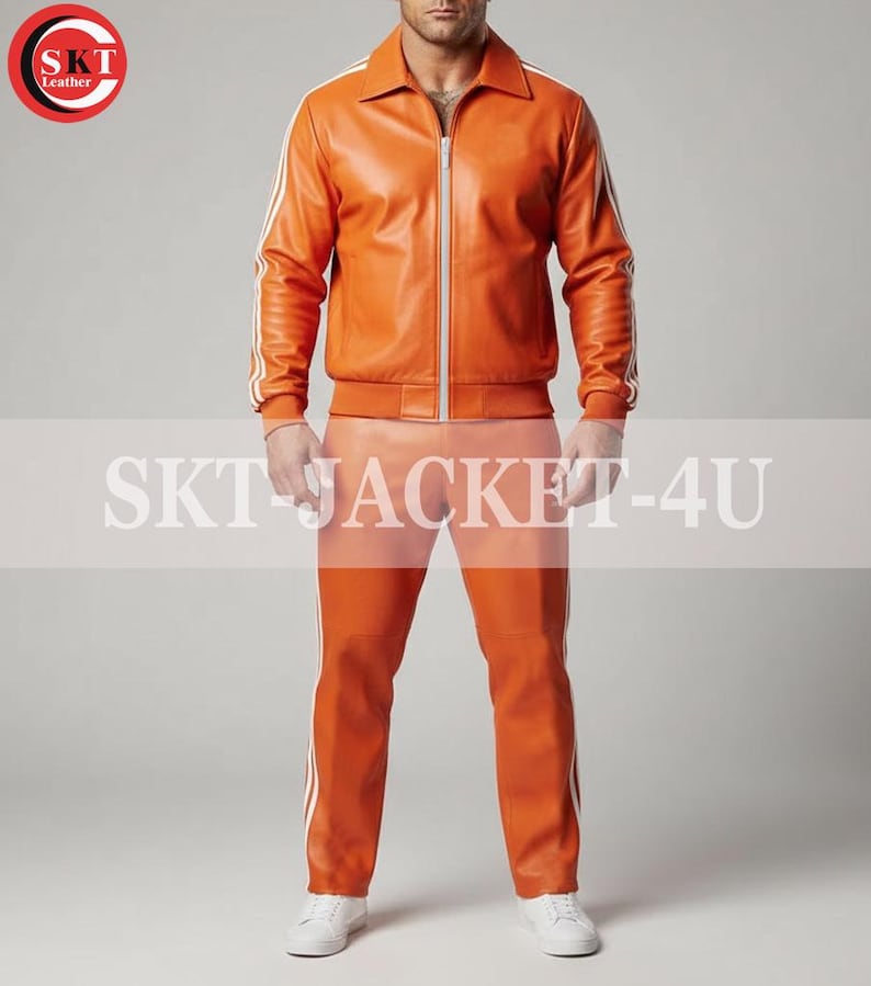 May include: Orange leather jacket and pants set with white stripes. The jacket has a zip-up front and a collar. The pants have a straight leg design. The text "SKT JACKET-4U" is displayed across the image.