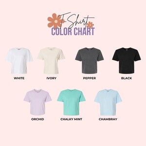 May include: A color chart for t-shirts, featuring seven different colors: white, ivory, pepper, black, orchid, chalky mint, and chambray. The text "T-Shirt Color Chart" is displayed at the top of the image.