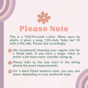 May include: A light pink graphic with the text "Please Note" in a retro font. The text explains the t-shirt is youth-sized, offering a snug fit for adults, and provides sizing recommendations for a fitted or more relaxed look.