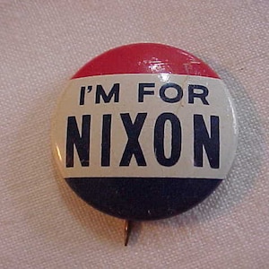 May include: A red, white, and blue button with the text "I'm for Nixon" in black letters.