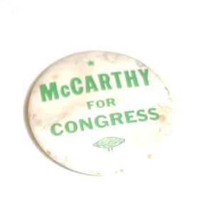 May include: White button with green text that reads "McCarthy for Congress".