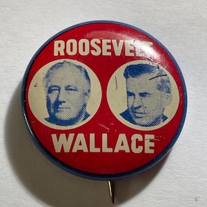 May include: Vintage political campaign button featuring portraits of Roosevelt and Wallace. The button has a red background with white text and portraits, and a blue border. A pin is attached to the back.