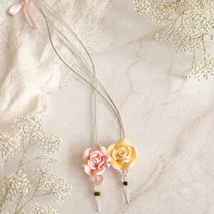 Paquete de 2 enhebradores para extensiones de cabello con forma de flor