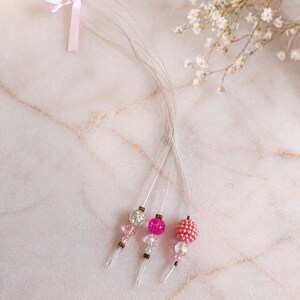 Paquete de 3 enhebradores para extensiones de cabello color rosa