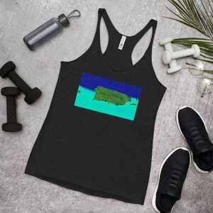 May include: Black racerback tank top with a colorful graphic of an island landscape. The artwork features shades of blue, green, and orange. The tank top is displayed with workout accessories, including dumbbells and a water bottle.