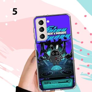 Puede incluir: Funda de tel&eacute;fono morada con un dise&ntilde;o gr&aacute;fico de un conejo robot y el texto "MENT & BANGBOO". La funda tiene un borde transparente y est&aacute; dise&ntilde;ada para un tel&eacute;fono inteligente.