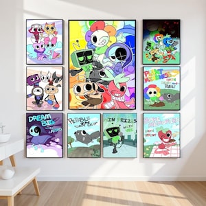 Op de afbeelding: Een verzameling ingelijste cartoonkunstprints met kleurrijke personages en tekst. De prints tonen verschillende ontwerpen, waaronder een bloemachtig personage, een robot en tekst met de tekst "Dream Big" en "Pebbles Day Out."