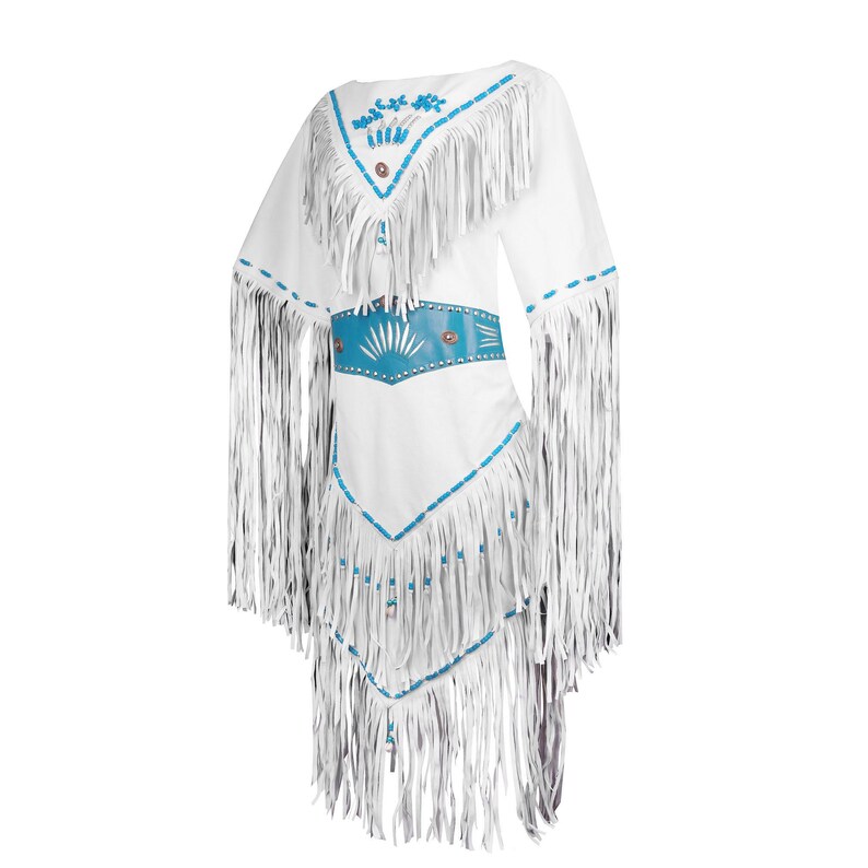 May include: White fringed dress with turquoise accents. The dress features a V-neckline, a turquoise belt, and decorative beading. The long fringe detail is on the sleeves and the bottom of the dress. The dress is a traditional style.