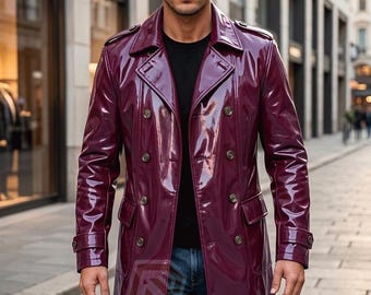 May include: A glossy, deep burgundy double-breasted trench coat featuring a wide collar, shoulder epaulets, and two rows of dark buttons. The coat has long sleeves with buckled cuffs and two front flap pockets. A logo with the text R LEATHERS is visible.