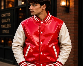 May include: A glossy red varsity jacket with cream-colored sleeves. The jacket features a snap-button front closure, white and red striped ribbed cuffs, a matching striped collar, and two side pockets with white trim. The material has a shiny finish.